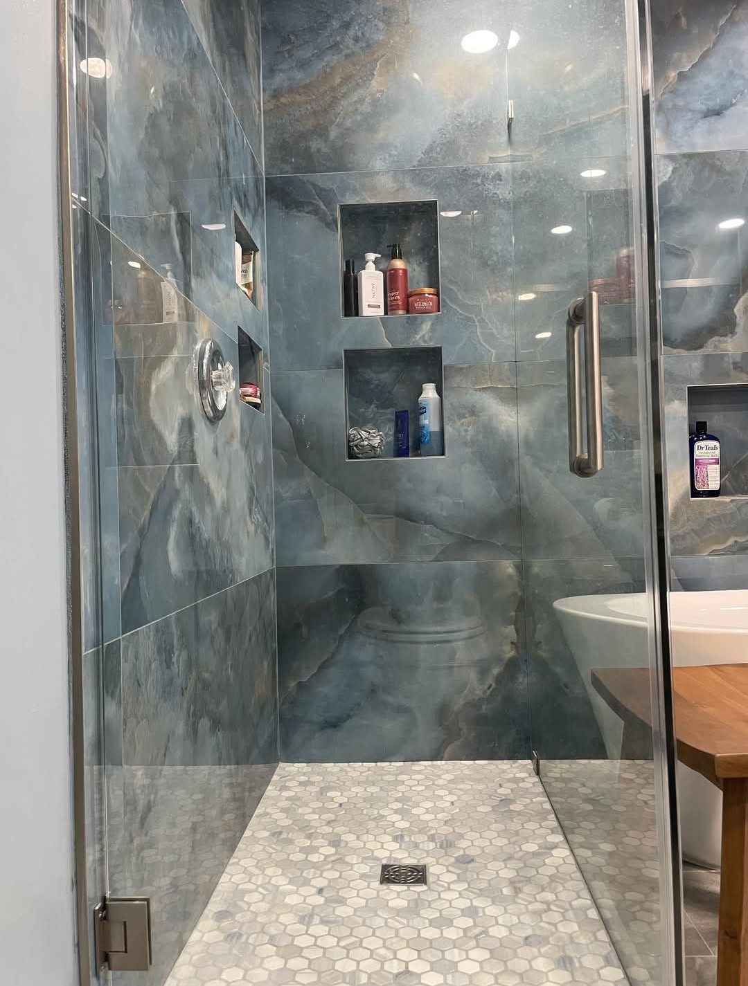 Newly renovated bathroom with custom tile work and modern fixtures by Excellent Home Improvement