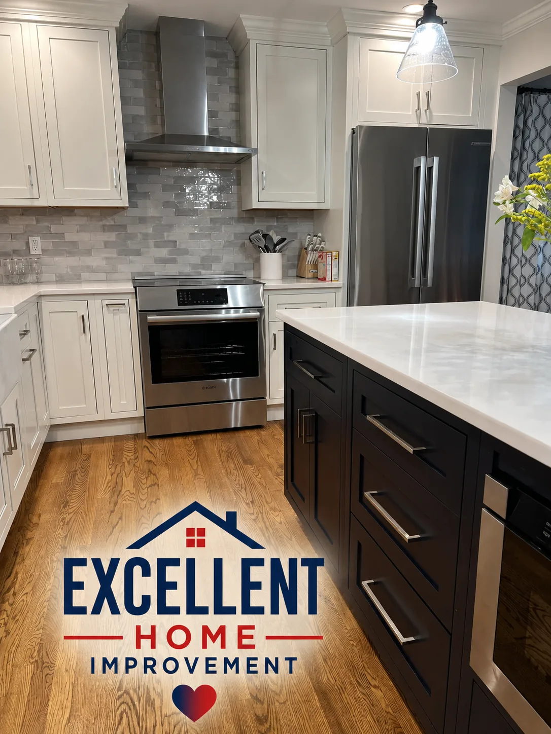 Two-tone kitchen remodel with black island, white cabinets and stainless appliances