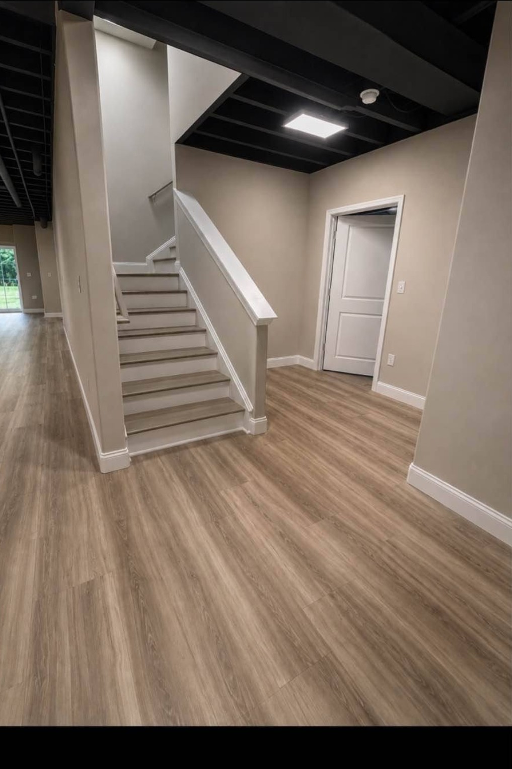 Completed Westchester basement build-out with moisture-resistant flooring and finished walls