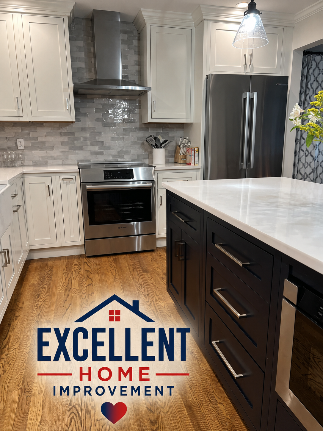 Two-tone kitchen remodel with black island, white cabinets and stainless appliances