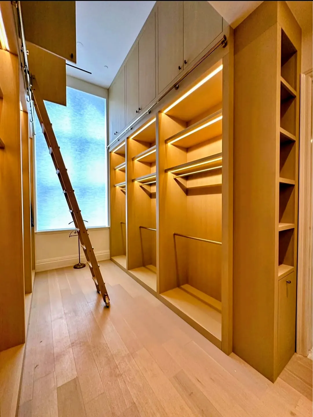 Custom illuminated wood closet installed during a Bronx home renovation