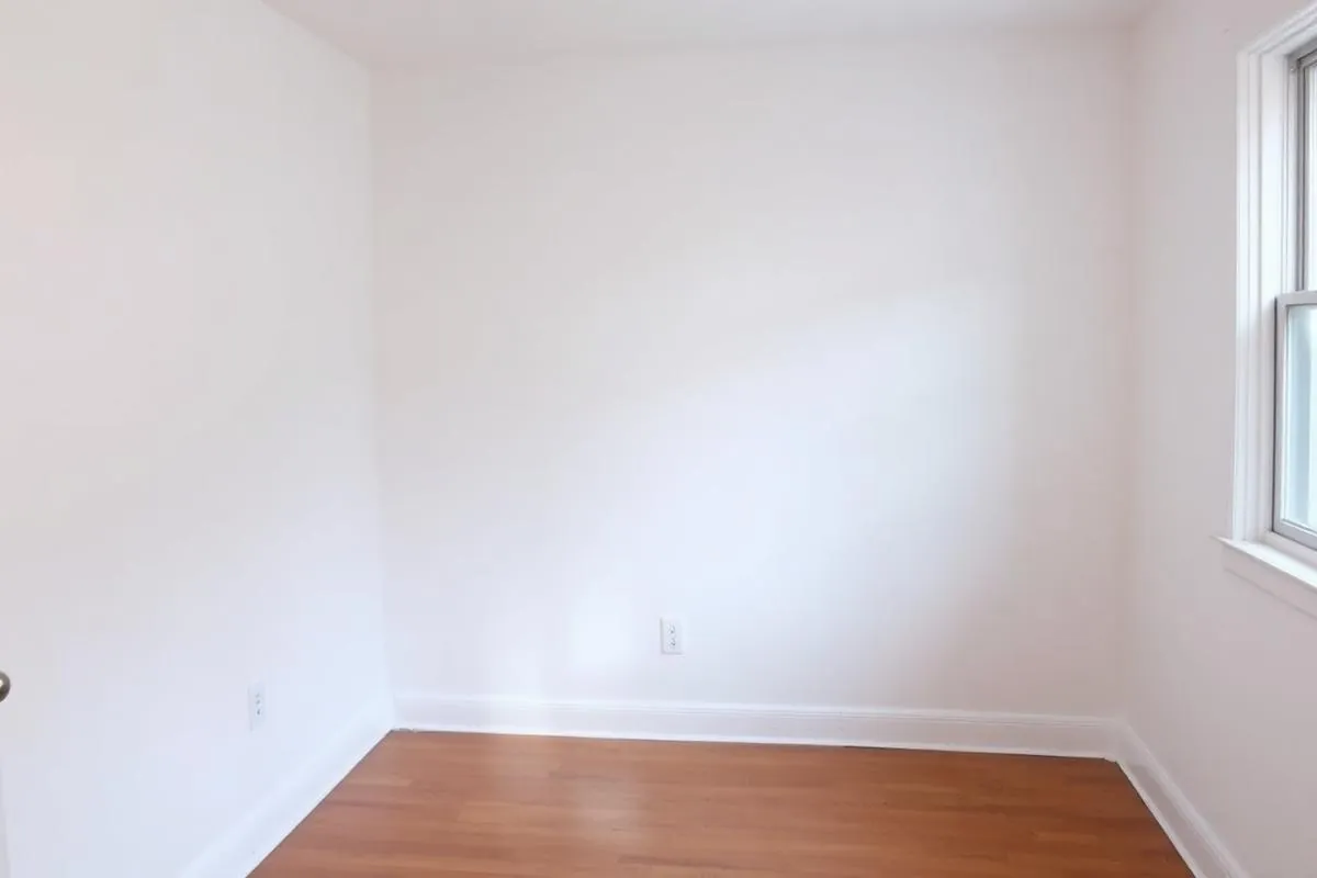 After: smooth Level 5 finished drywall walls painted white in a Bronx apartment by a New York drywall installation expert